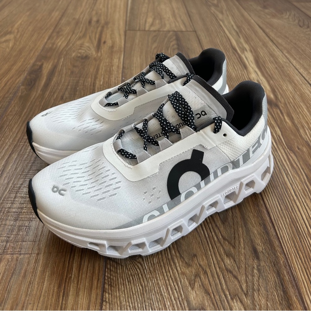 On Running White and Black Athletic Shoes